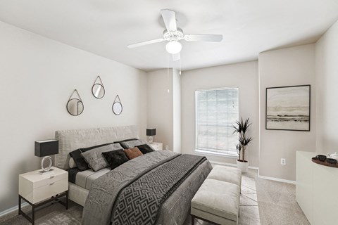 a bedroom with a large bed and a ceiling fan